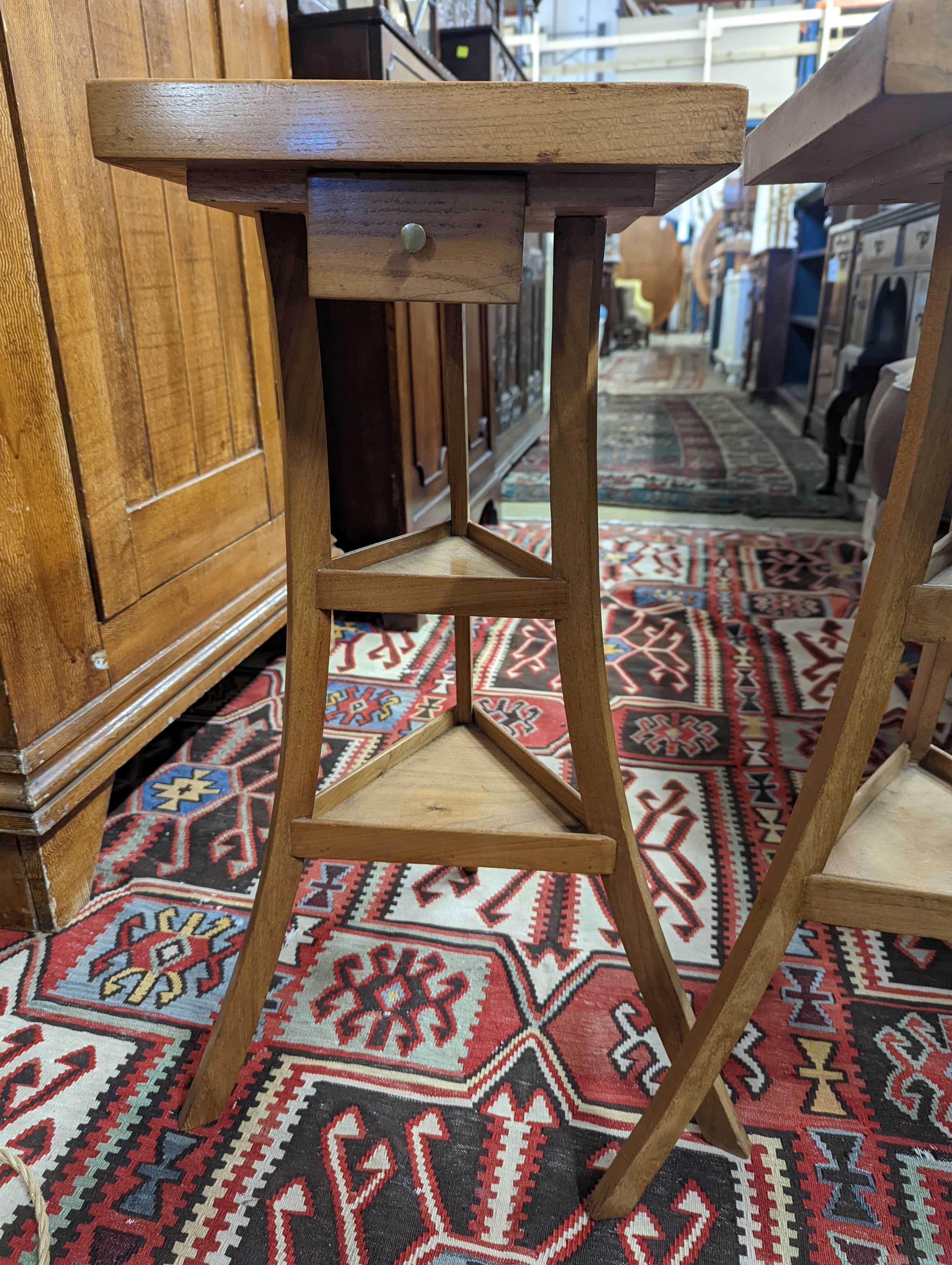 A pair of 1950's French design fruitwood square top three tier occasional tables, width 31cm, height 68cm